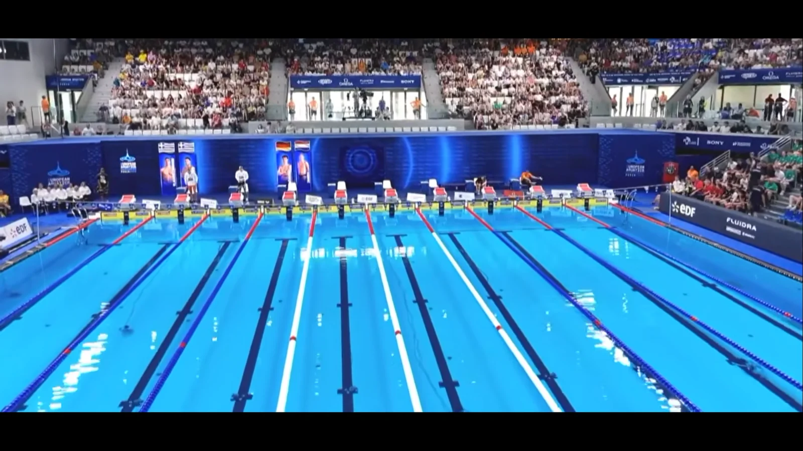 Video wall seen across the full width of the pool